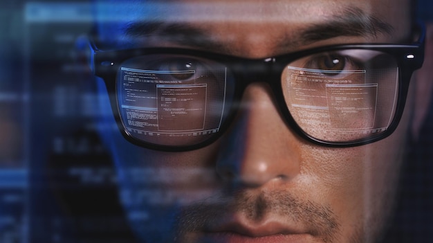 close up of asian male hackers face in vr glasses