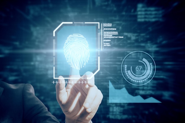 Close up of businessman hand pointing at creative glowing blue fingerprint scanner interface on dark background Technology information and identification concept Double exposure
