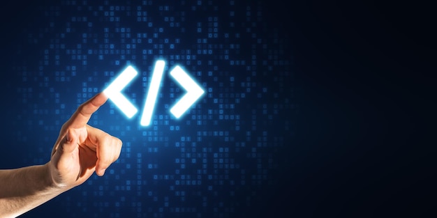 close up of businessman hand pointing at glowing programming code on blue binary coding background with mock up place program and software development concept