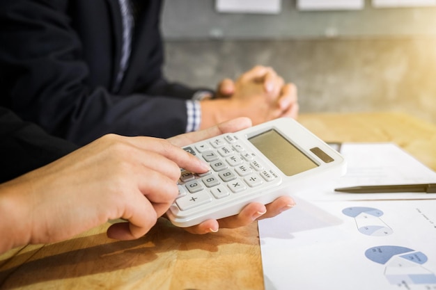 Close-up of businesswoman using calculator
