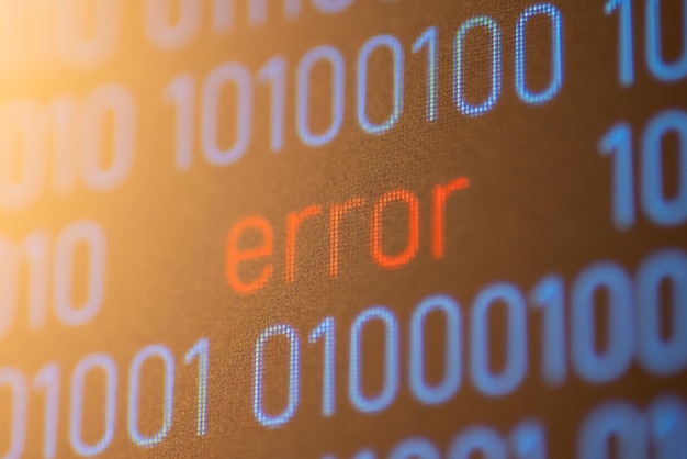Close up of computer screen with inscription Error between binary code