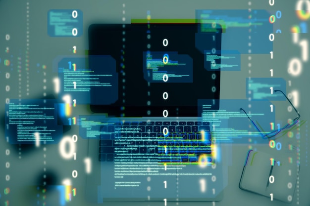 Close up of desktop with notebook computer and abstract coding binary code hologram on blurry background Artificial intelligence and development concept Double exposure