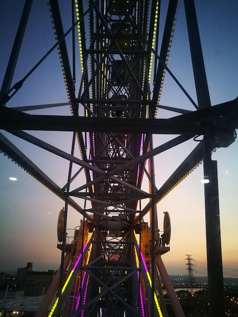 Close-up of ferris wheel in park at dusk