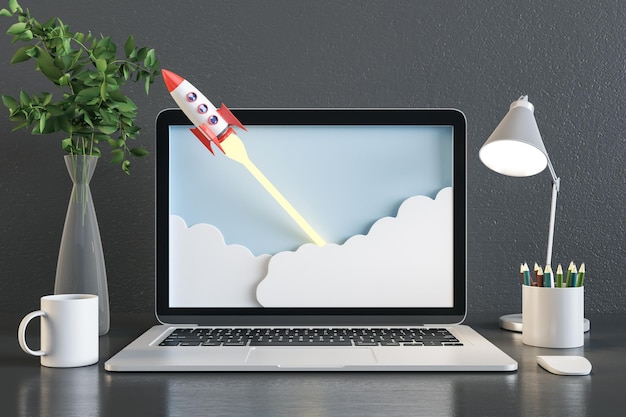 close up of gray designer desktop with abstract rocket on laptop screen coffee cup decorative plant lamp and supplies startup and workplace concept 3d rendering