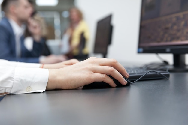 Close-up of hand using computer mouse