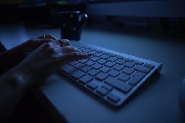 Close-up of hands using keyboard