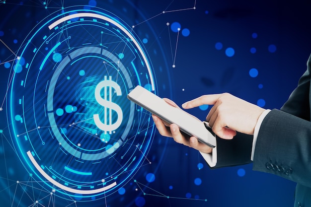 Close up of male hand pointing at mobile phone with glowing round dollar hologram with polygonal mesh and bokeh circles on blurry blue background Digital banking money and finance concept