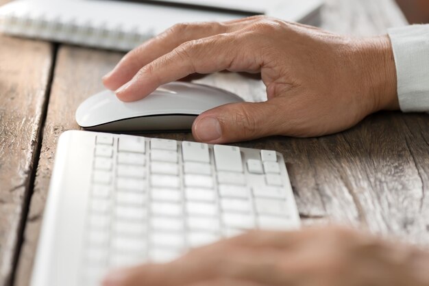 Close-up of man using computer on table