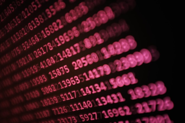 Close-up of pink binary codes on screen