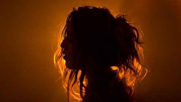 close-up of silhouette woman against gray background
