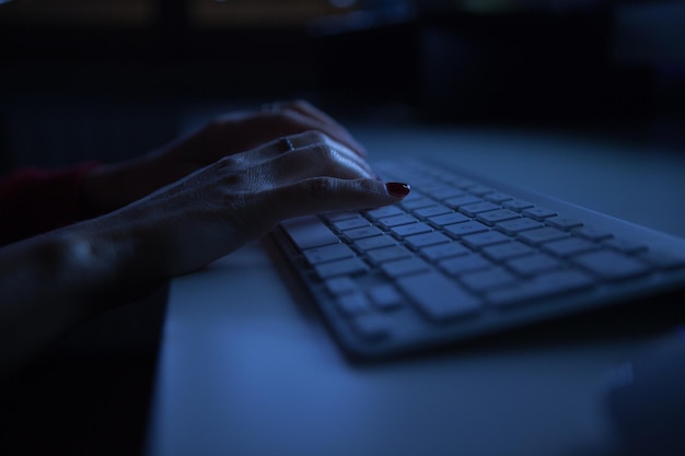 Close-up of woman using keyboard