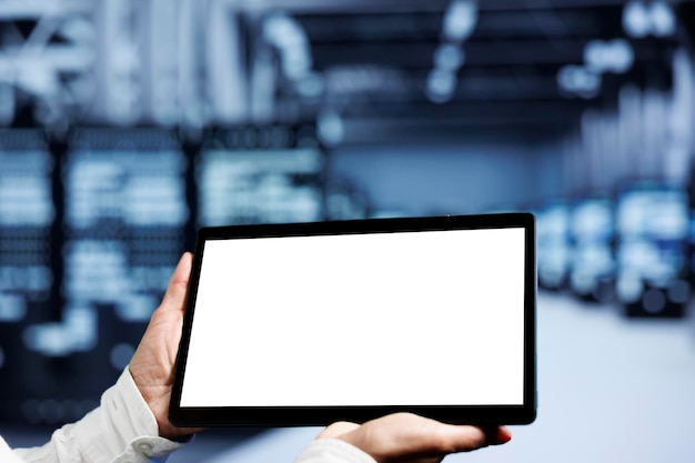 Close up shot of mock up tablet used by IT developer in supercomputer room delivering massive computing power, capable of processing and storing vast amounts of data and controlling network resources