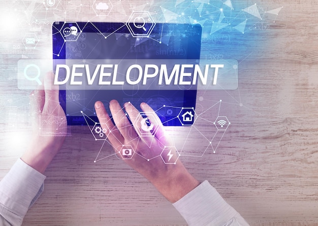 Closeup of a tablet searching DEVELOPMENT inscription hitech computing concept