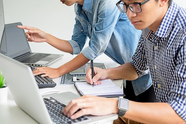 Colleagues using technologies at desk in office