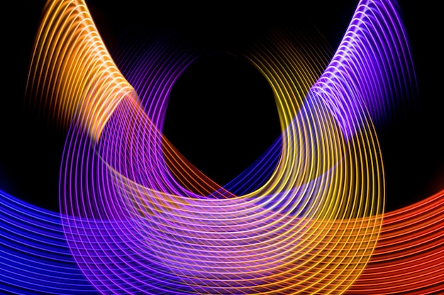 Colorful pink yellow orange and blue neon spiral linesAbstract background of blue neon glowing light shapes Bright stripes for poster website brochure printxA
