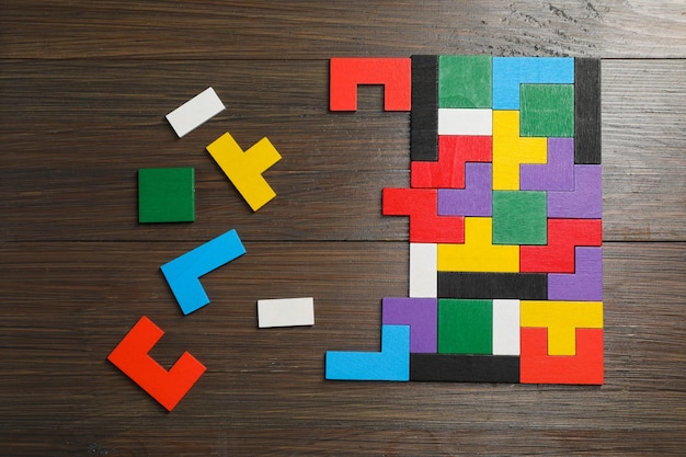 Colorful puzzle pieces on wooden table top view