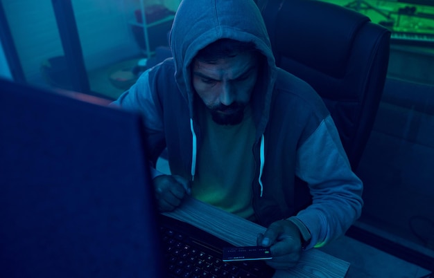 Computer credit card or neon hacker hacking online software fintech server or fraud password phishing Ransomware developer man programming cybersecurity for scam or programmer coding malware code