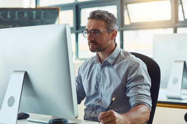 Computer finance and businessman in office with research for fundamental trading with stock market Notes technology and male broker studying targets for cryptocurrency investment in workplace