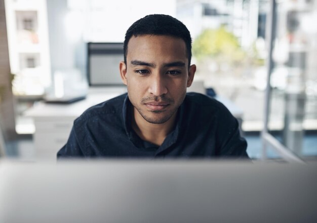 Computer focus and business man reading online for information technology software development and web code Coding programming and IT person or worker on desktop pc for system review or check