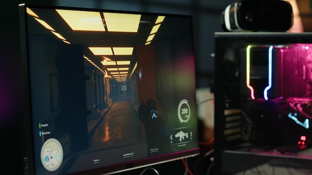Computer screen showing first person shooter game left open at night