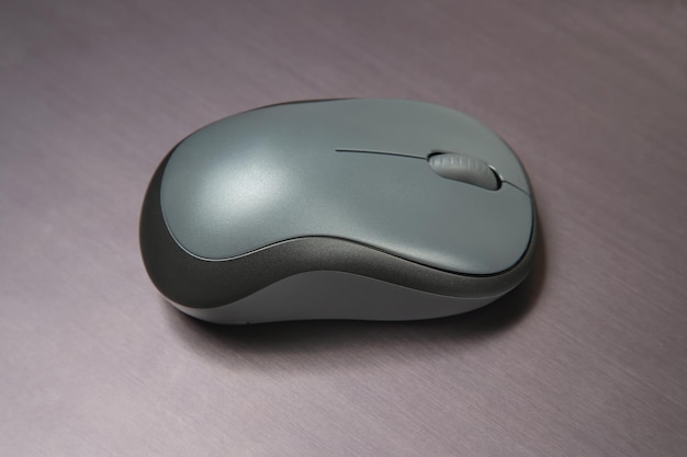 Computer wireless mouse on a gray table closeup electronic personal industry