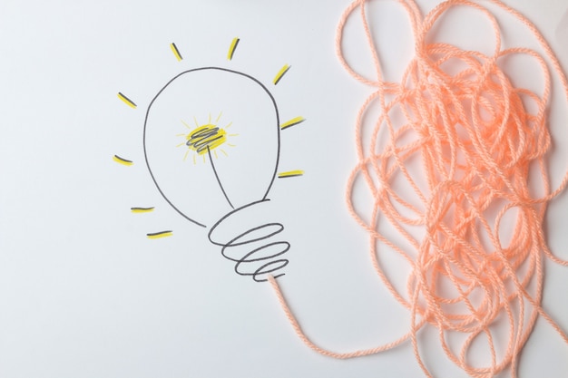 Concept creative idea. concept of creative idea. painted light bulb on a light background. metaphor, inspiration.