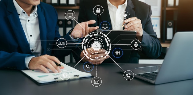 Copyright or patent concept Person hand using laptop computer tablet and smartphone with virtual screen copyright icon trademark Creation ownership against piracy at office