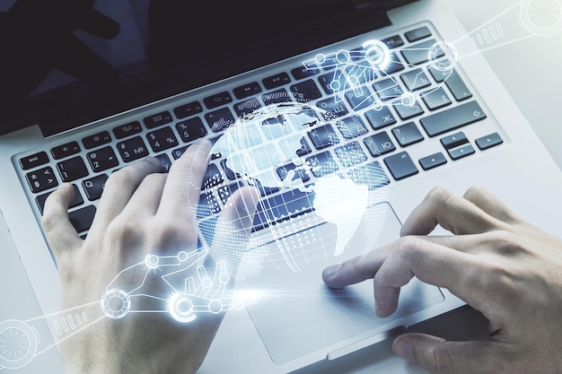 creative concept of robotics technology with globe sketch and hands typing on laptop on background robot development and automation concept multiexposure