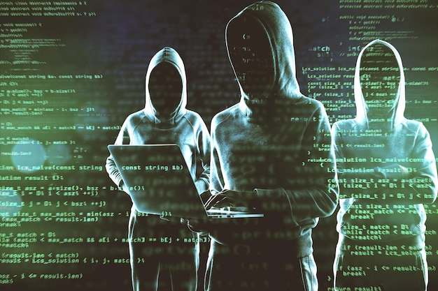 Creative image of a group of hackers in hoodies standing on abstract dark coding backdrop Malware coding phishing and theft concept Double exposure