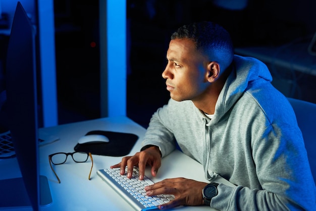 Crime black man or hacker stealing on computer for cyber scam malware or phishing for online data Programmer password theft or pc software update on tech for hacking server on website at night
