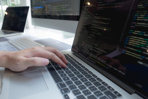 Cropped hand of computer programmers brainstorming in office