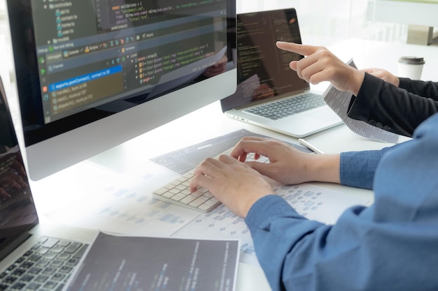 Cropped hand of computer programmers brainstorming in office