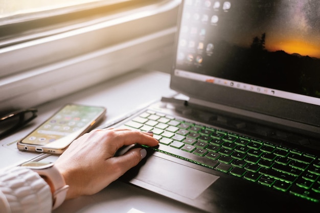 Cropped hand using laptop