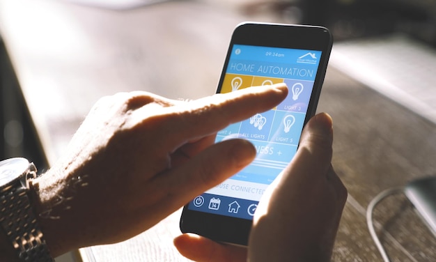 Cropped hands of man using mobile phone at table