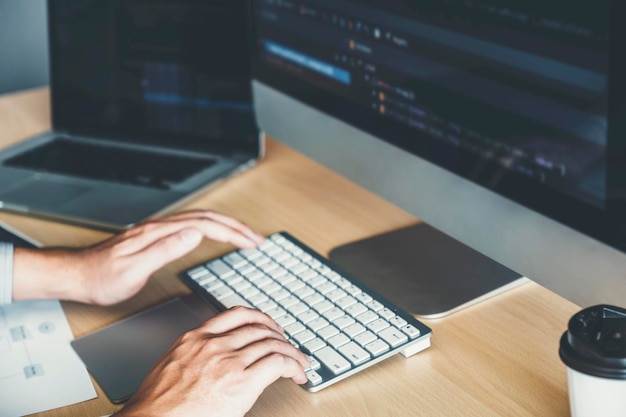Cropped hands using computer at table in office