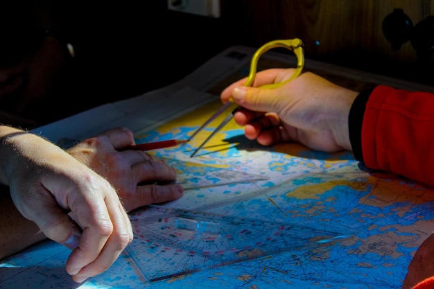 Cropped hands with map and tool