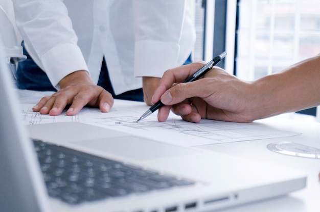 Cropped image of business colleagues working at desk in office