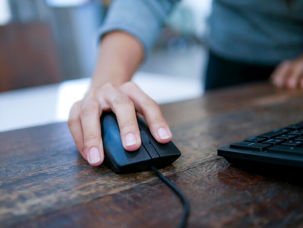 Cropped image of person using computer on table