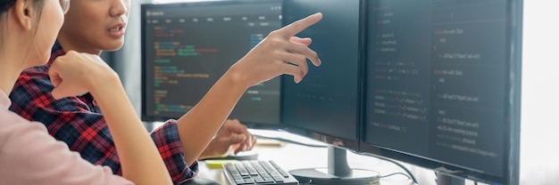 Cropped image of professional programer team collaboration discuss about web coding while coworker point java script displayed on computer at modern company office Closeup Burgeoning