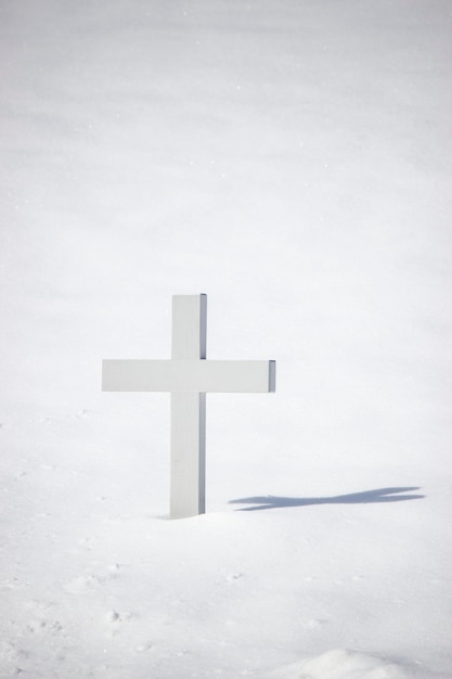 cross on snow covered field