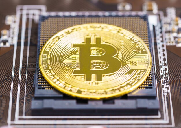 cryptocurrency bitcoin coins on circuit board. blockchain technology bitcoin mining concept