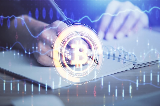 Cryptocurrency hologram over hands taking notes background Concept of blockchain Multi exposure