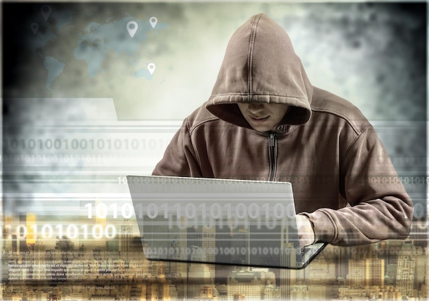 Cyber hacker using laptop on dark background