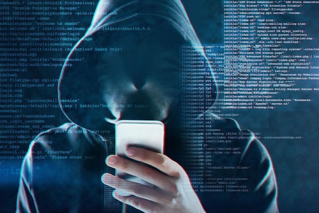 Cyber security smartphone and hacker internet web technology and man for online cybercrime Data protection secured and website access programming virus in system and person with hoodie coding