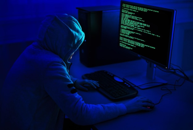 Cybercrime and hacking concept unrecognizable hacker using computer virus program for cyber attack