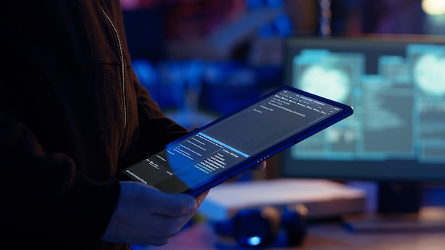 Cybercriminal in bunker masking his location hacking with tablet