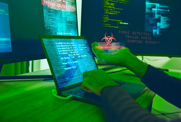 Cybersecurity crime and hands of hacker with virus in neon office with code fraud and danger Software ransomware and web programmer on cyber attack password thief coding online scam and hacking