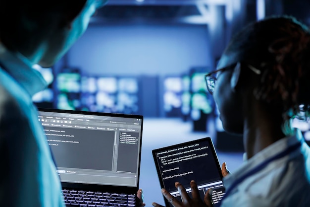 Data center specialists code on tablet