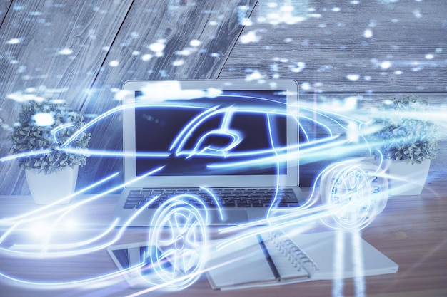 Desktop computer background in office with automobile hologram drawing Multi exposure Tech concept