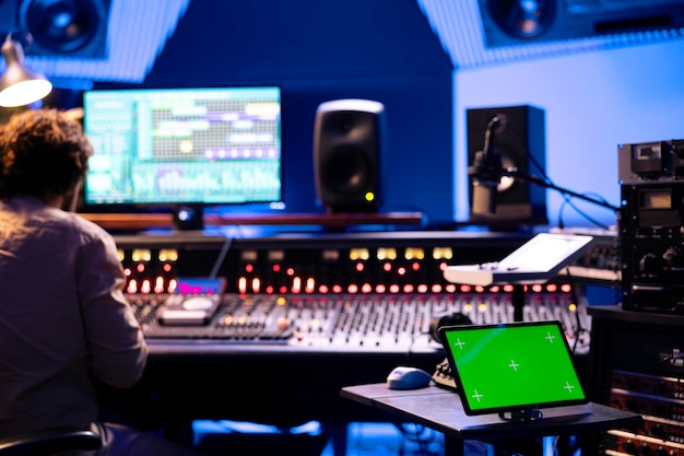 Device with mockup screen in control room at professional studio